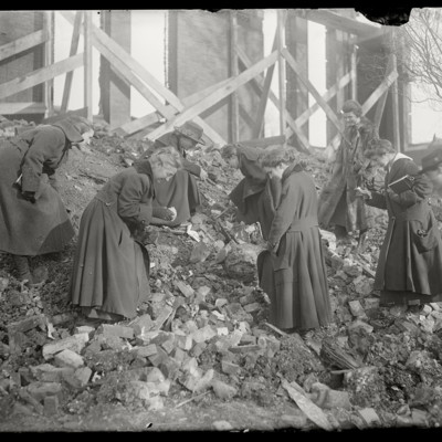 A group of women searching through the rubble.