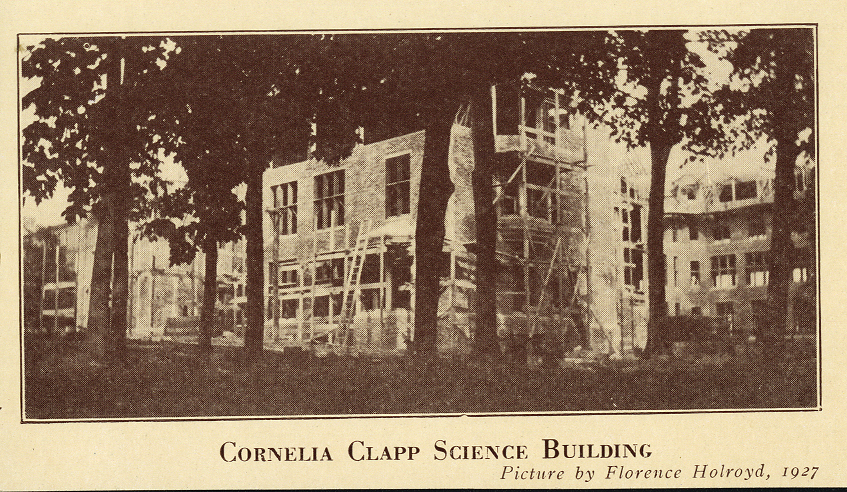 Scaffolding put up as Clapp Building is built. Trees obstruct a full view. Text below reads "CORNELIA CLAPP SCIENCE BUILDING. Picture by Florence Holroyd, 1927."