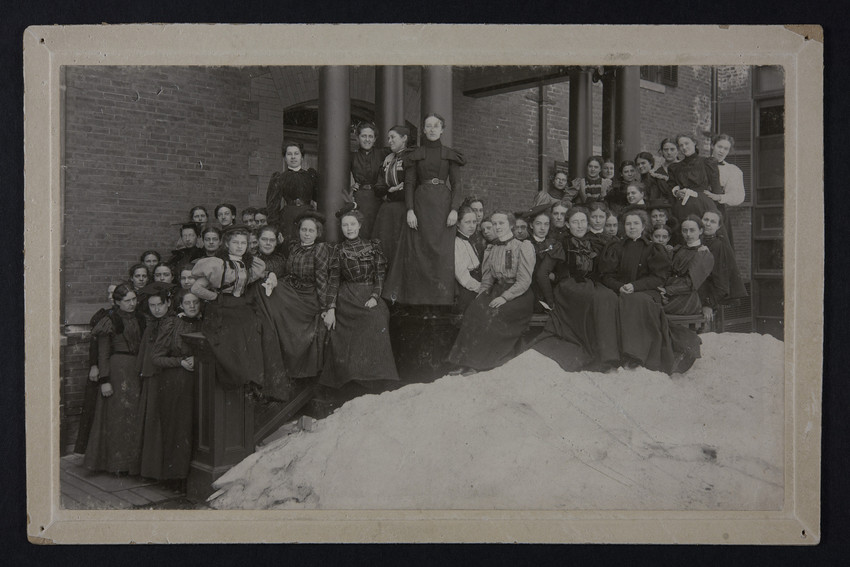 Van Deman posing with neighbors in front of Pearsons Hall at Mount Holyoke College in south Hadley, MA. March 9, 1898.