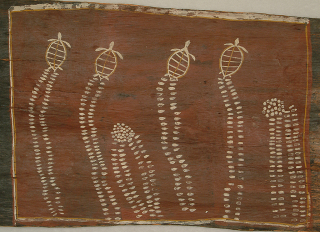 A bark painting of four turtles, two groups of eggs, and the impressions the turtles leave in the sand. The painting is done in white and yellow against a red background. 