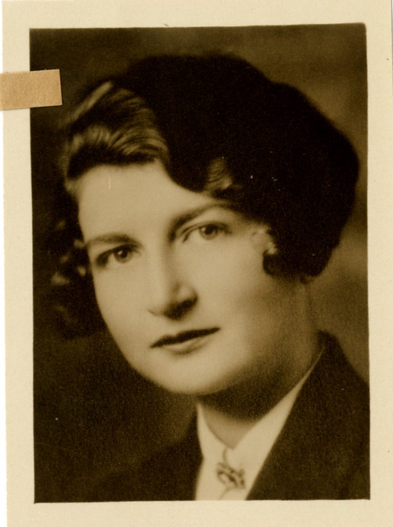 Tanetta Vester, shown in a waist-up shot, wears a white-collared shirt with hair cut short, Llamarada 1930.