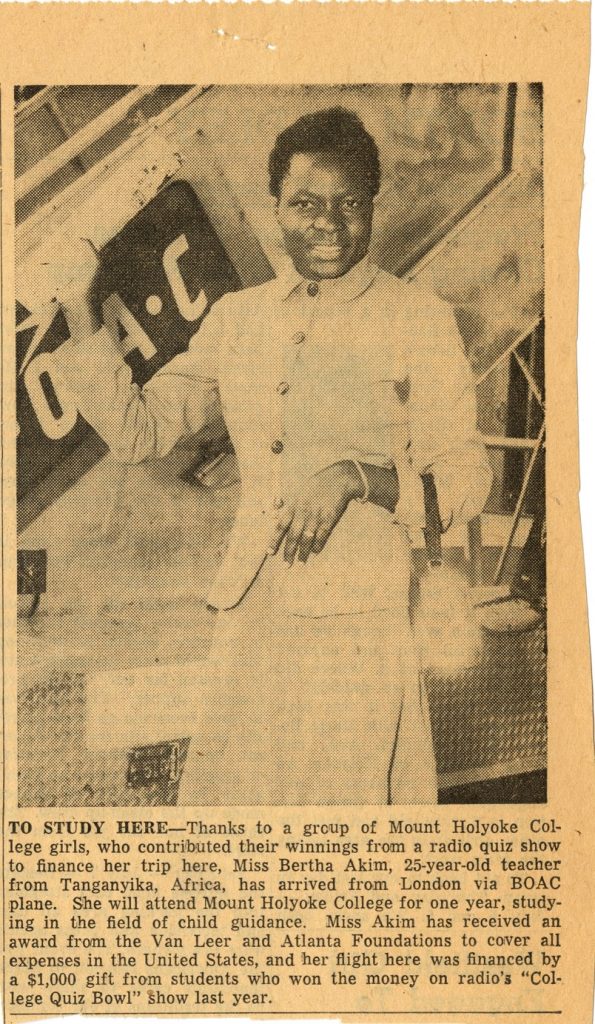 News clipping featuring a grayscale image of Bertha Akim standing by airplane stairs after traveling in a light skirt-suit. The caption of the image describes her scholarship and background.