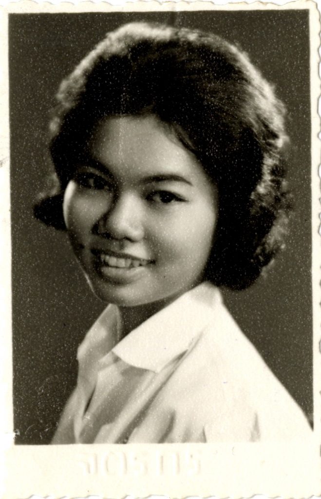 Nopamart Intarasalee smiles in a waist-up shot, her hair cut short qnd wearing a white shirt.
