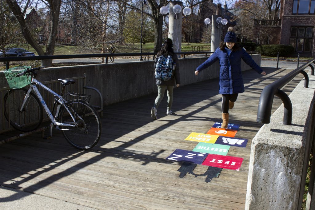 Image of person jumping on colorful hopscotch