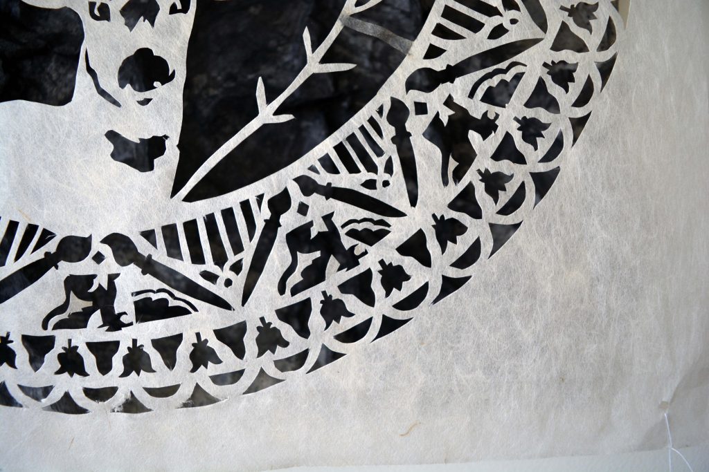 detail of kozo paper, cut with various designs, including a deer