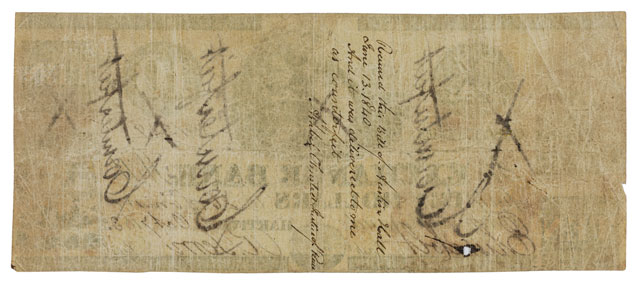 The reverse of the ten dollar bank note, unadorned save writing. The black counterfeit marks from the front bleed through slightly, and there are 4 lines of cursive writing, seemingly from a judge.