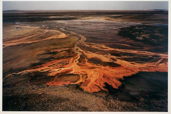 What elements of this photograph stand out for you? Do you think this photograph is beautiful? What attitude do you think the photographer has towards nature? How does finding out that the intense colors in this photograph are due to toxic chemicals that have been dumped onto the land?